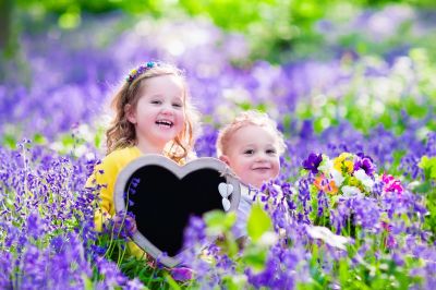 Kinder mit Herztafel im Blumenfeld